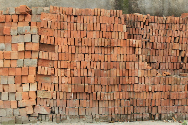 Neatly arranged red clay bricks texture