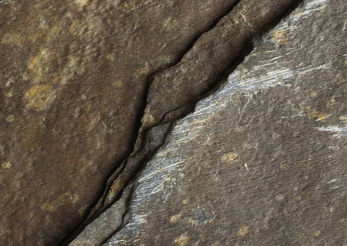 Surface of gray rock with cracks texture