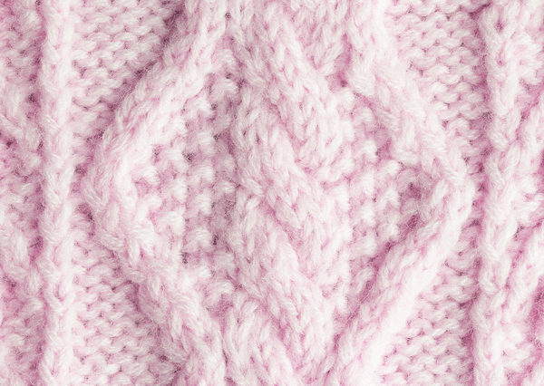 Close-up of pink wool knitting fabric texture